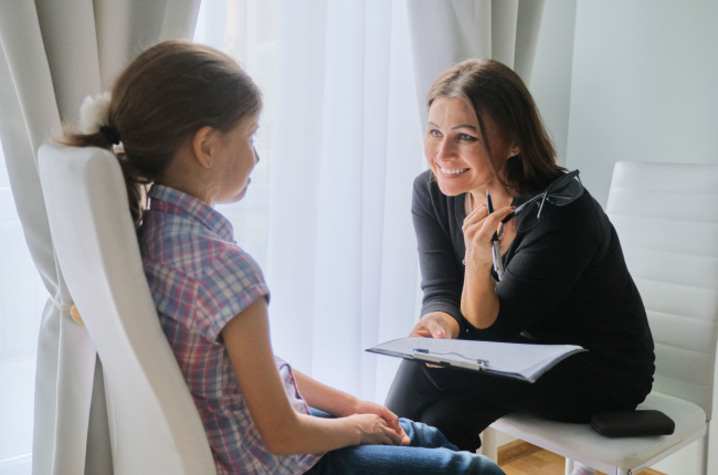 social worker chatting with a young girl