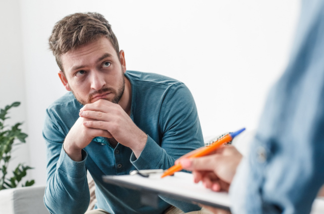 man listening to social worker speak