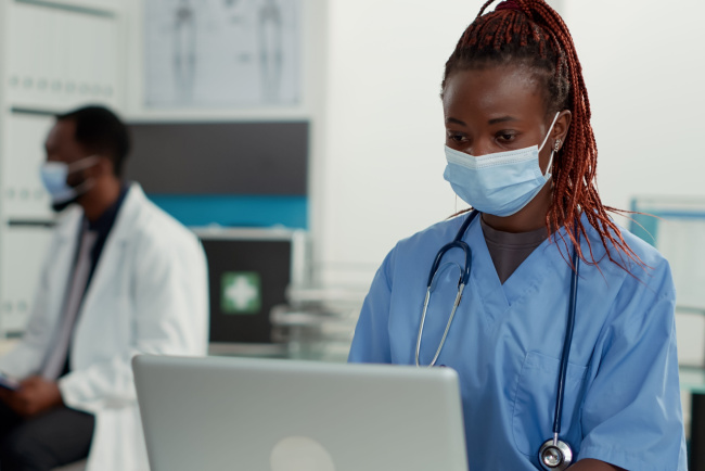 forensic nurse working on a laptop