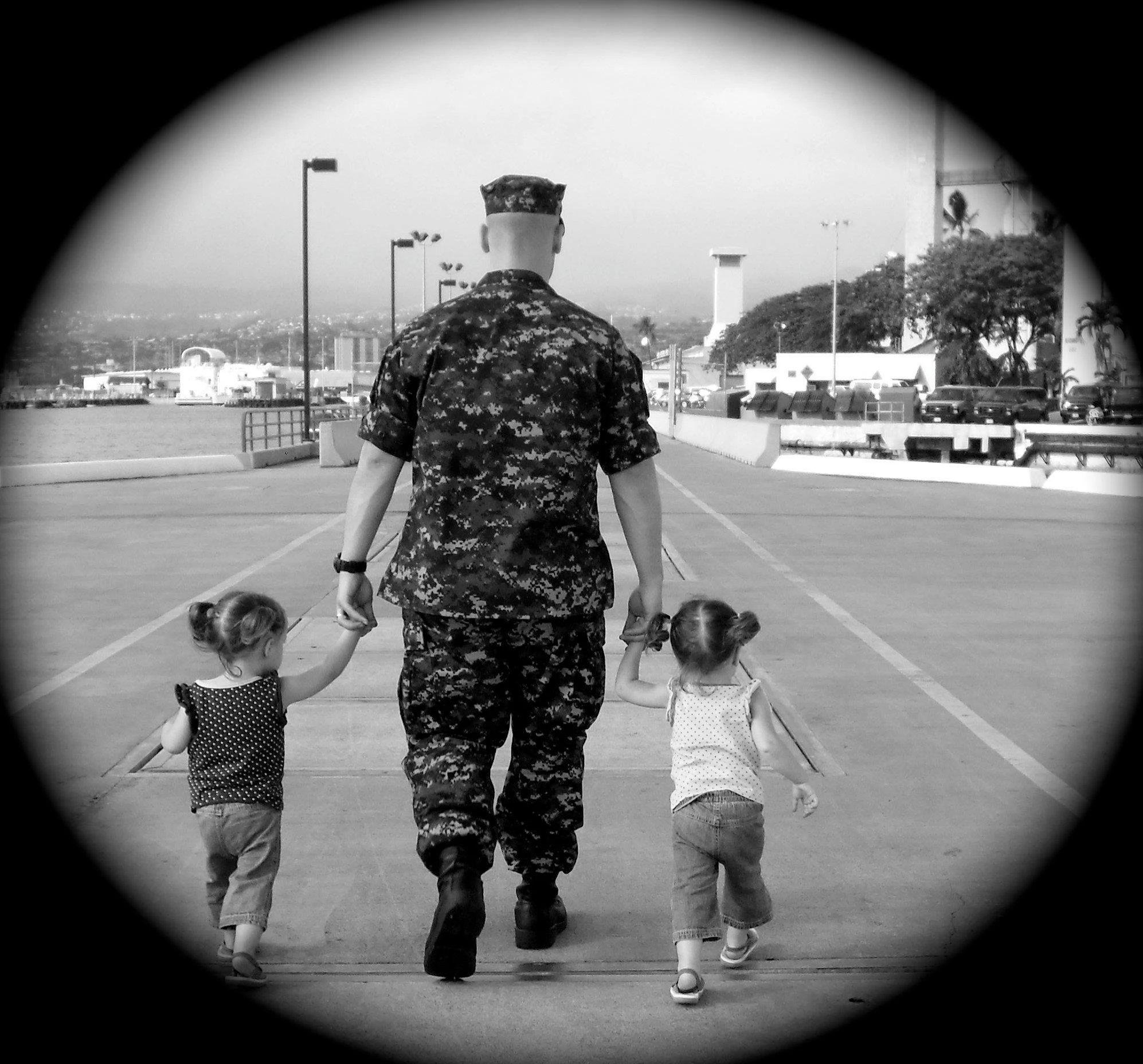 Nick walking with his twins on the submarine piers in Pearl Harbor, 2011