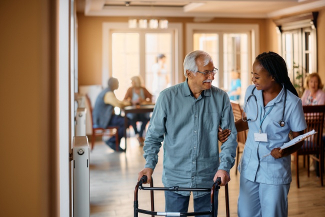 nurse helping elderly man