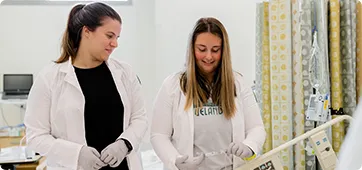two smiling nurses representing the online MSN nurse educator program at Cleveland State University